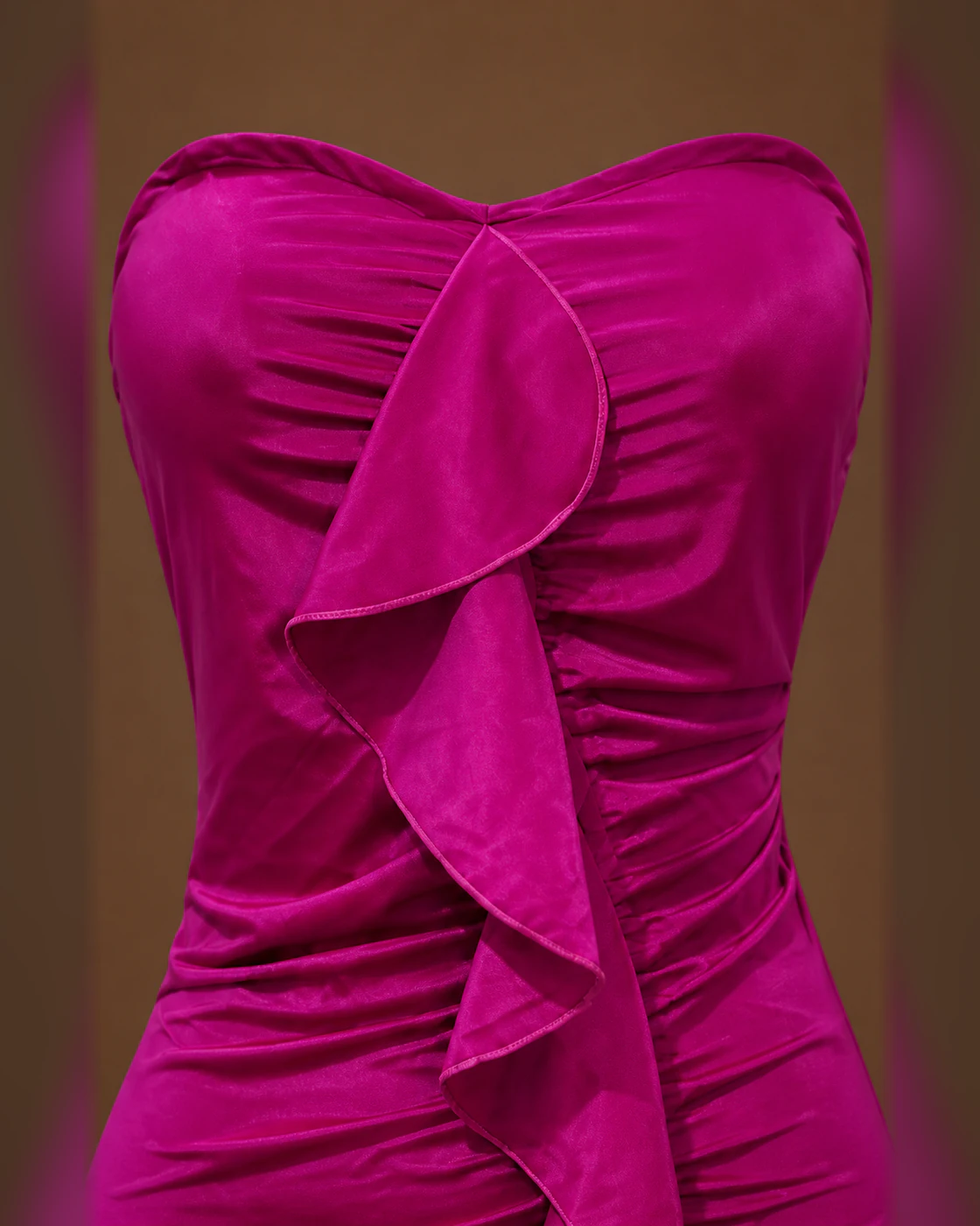 Fuchsia Strapless Ruched Cascade-Ruffle Mini Dress · fabric detail.